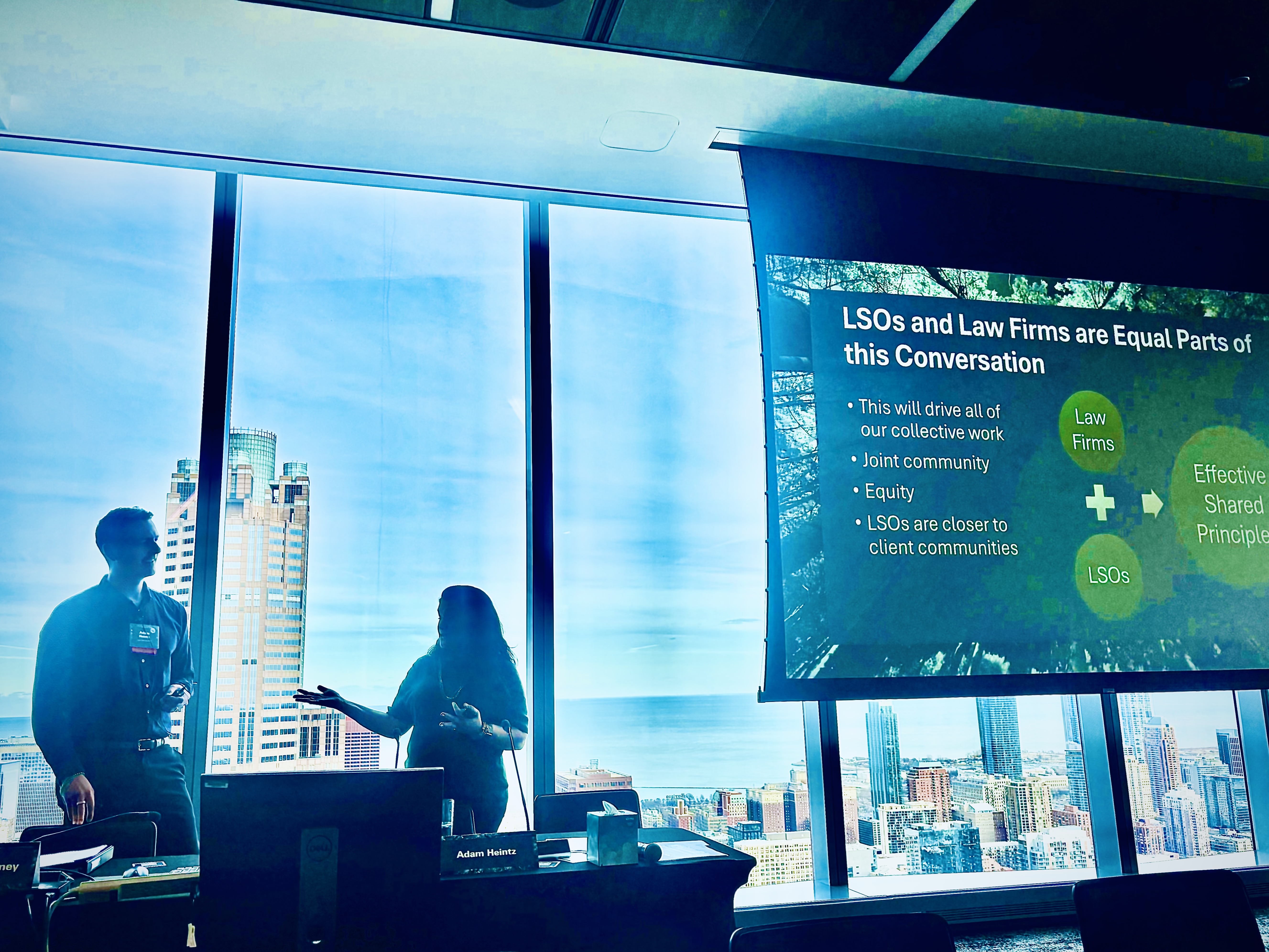 Two presenters discussing the presentation on the screen.