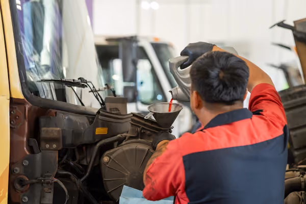 Mechanic performing oil services in Alvin, TX