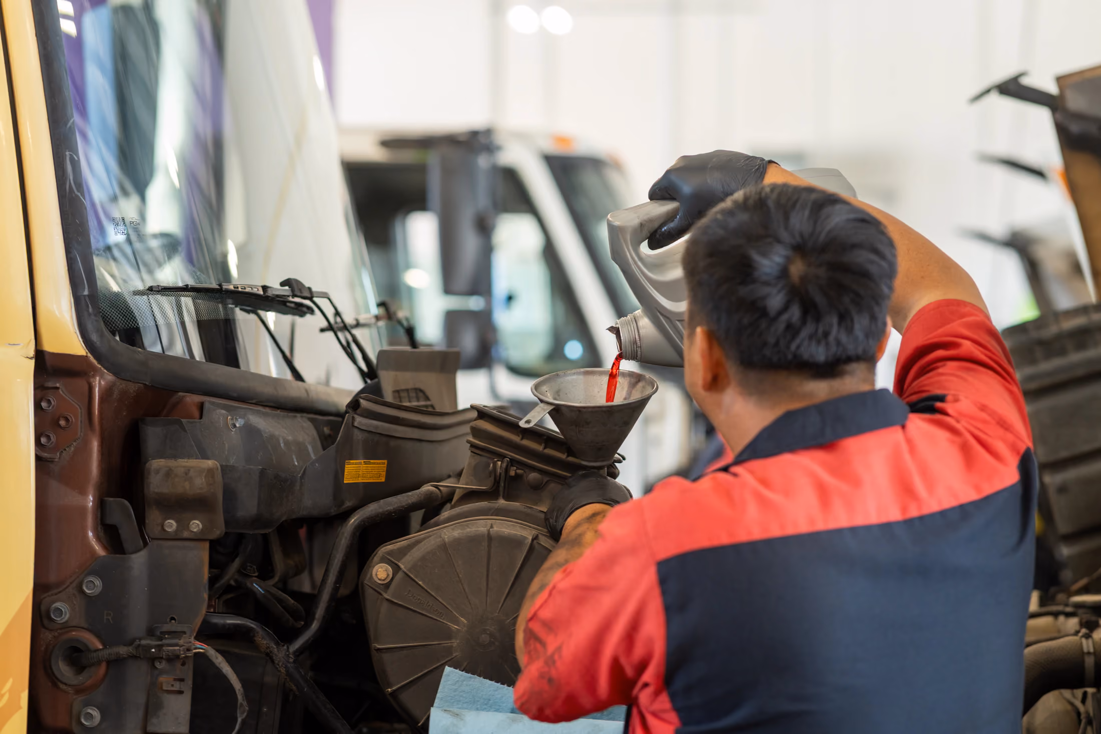 Mechanic performing oil services in Alvin, TX