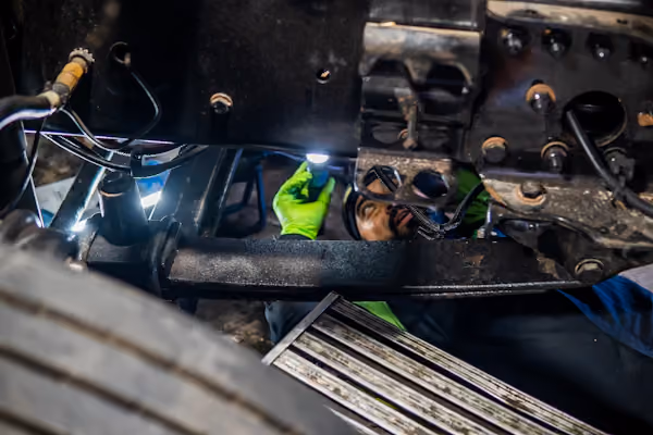 Mechanic performing suspension repair in Alvin, TX