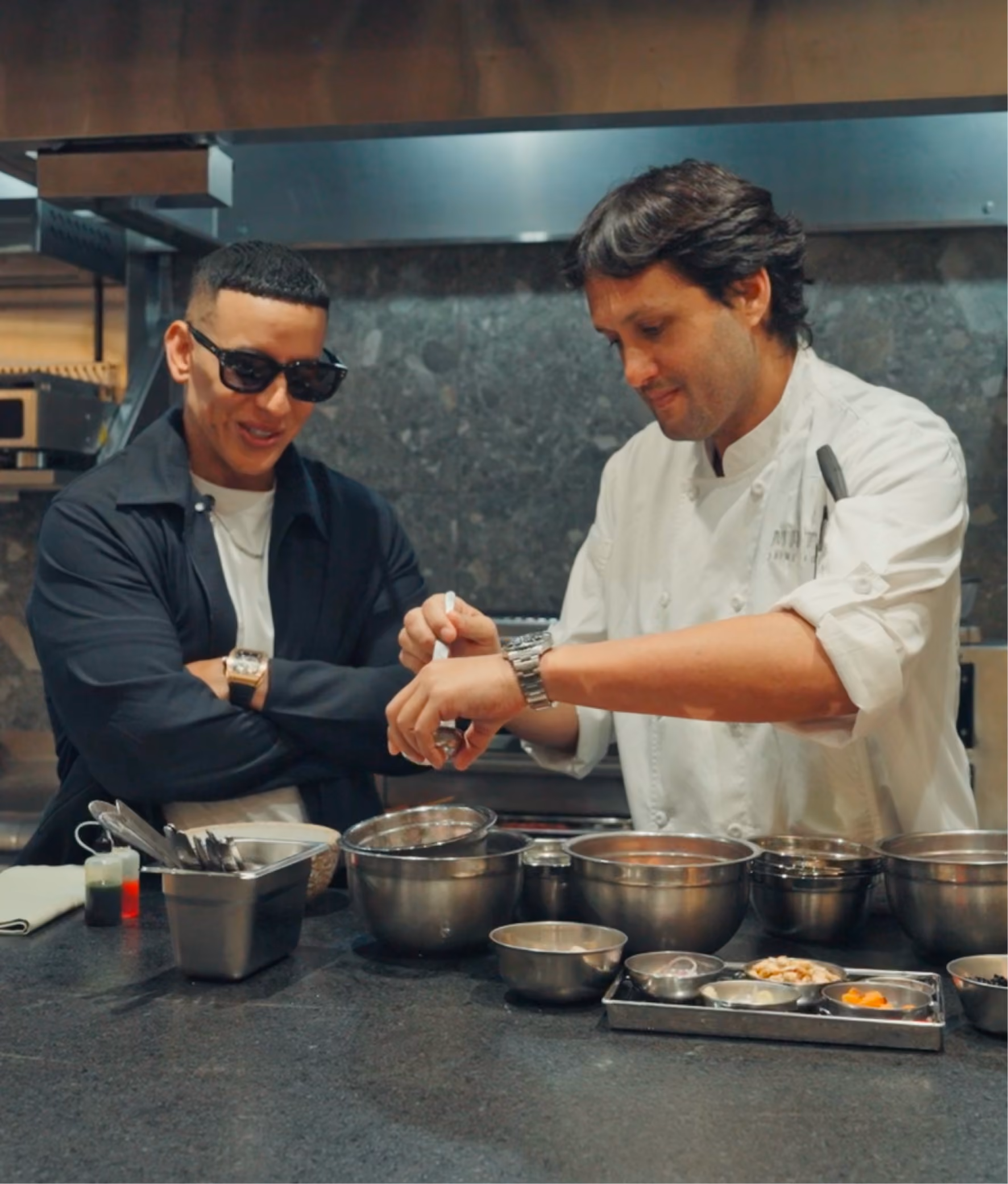 Daddy Yankee and Jaime Pesaque in a kitchen cooking