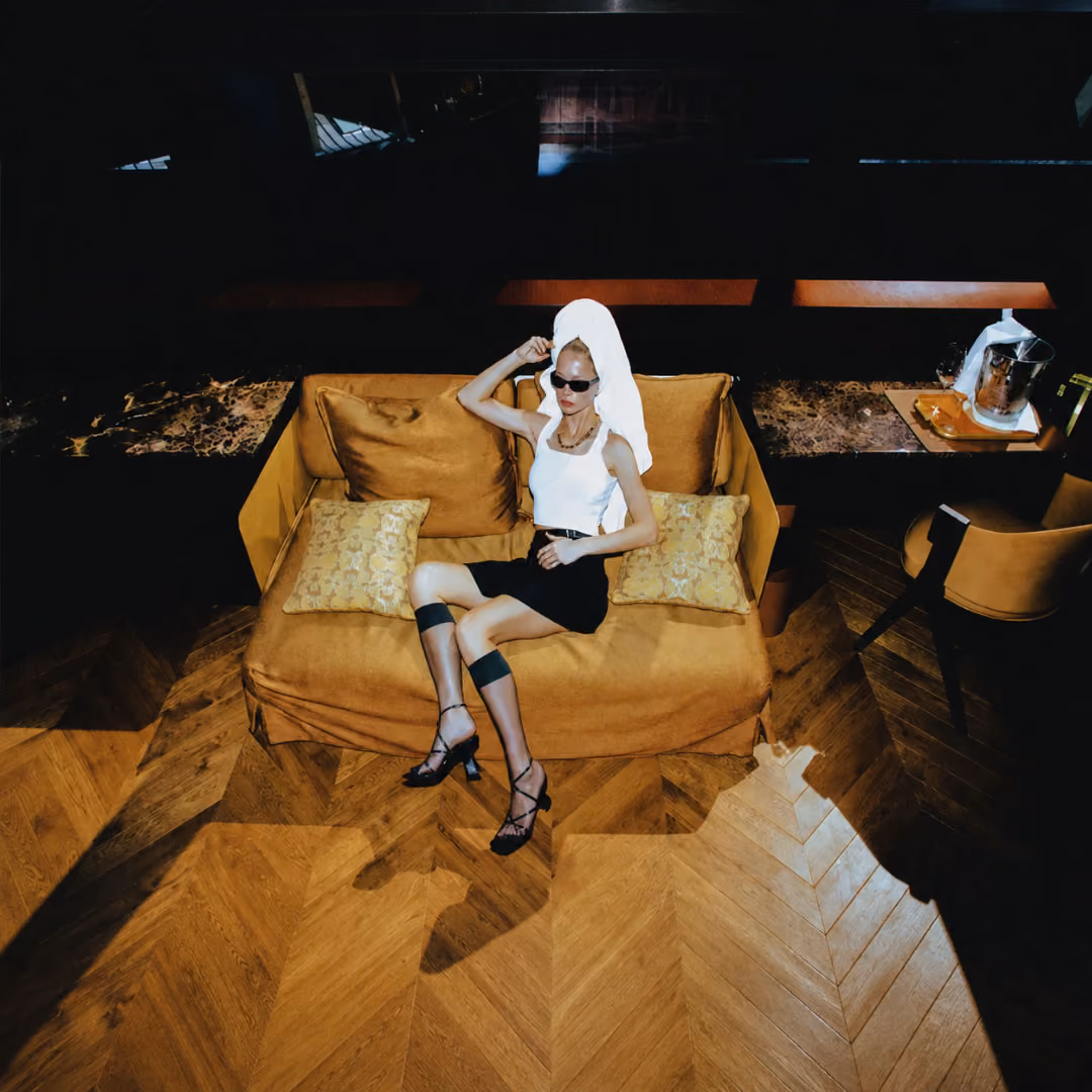 Chic woman on her coach with a towel on her head