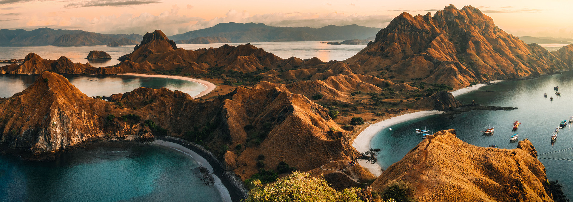 Aerial photo of a mountain range pushing up form the ocean.