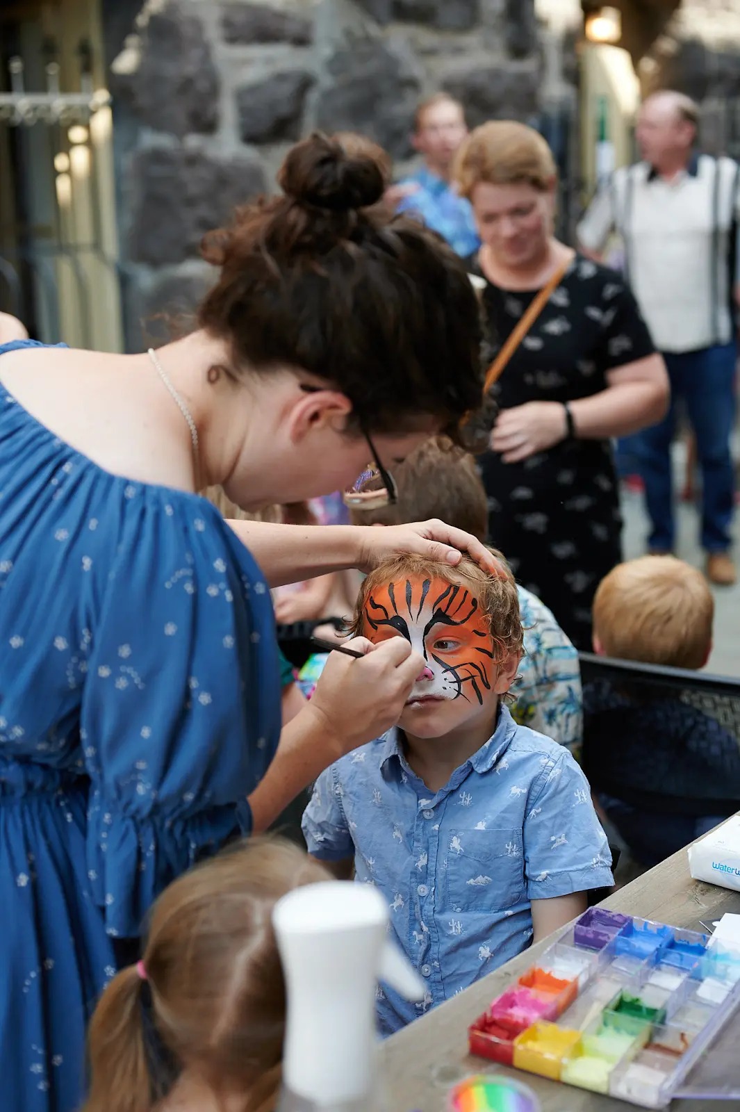 A child getting face paint at a parish celebration