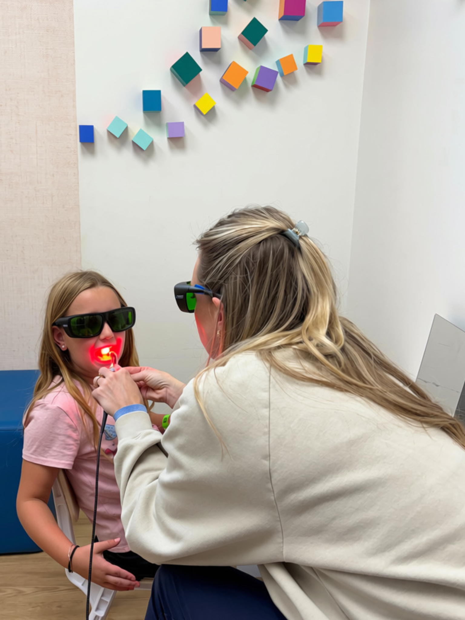 Parkview provider using laser therapy with a child.