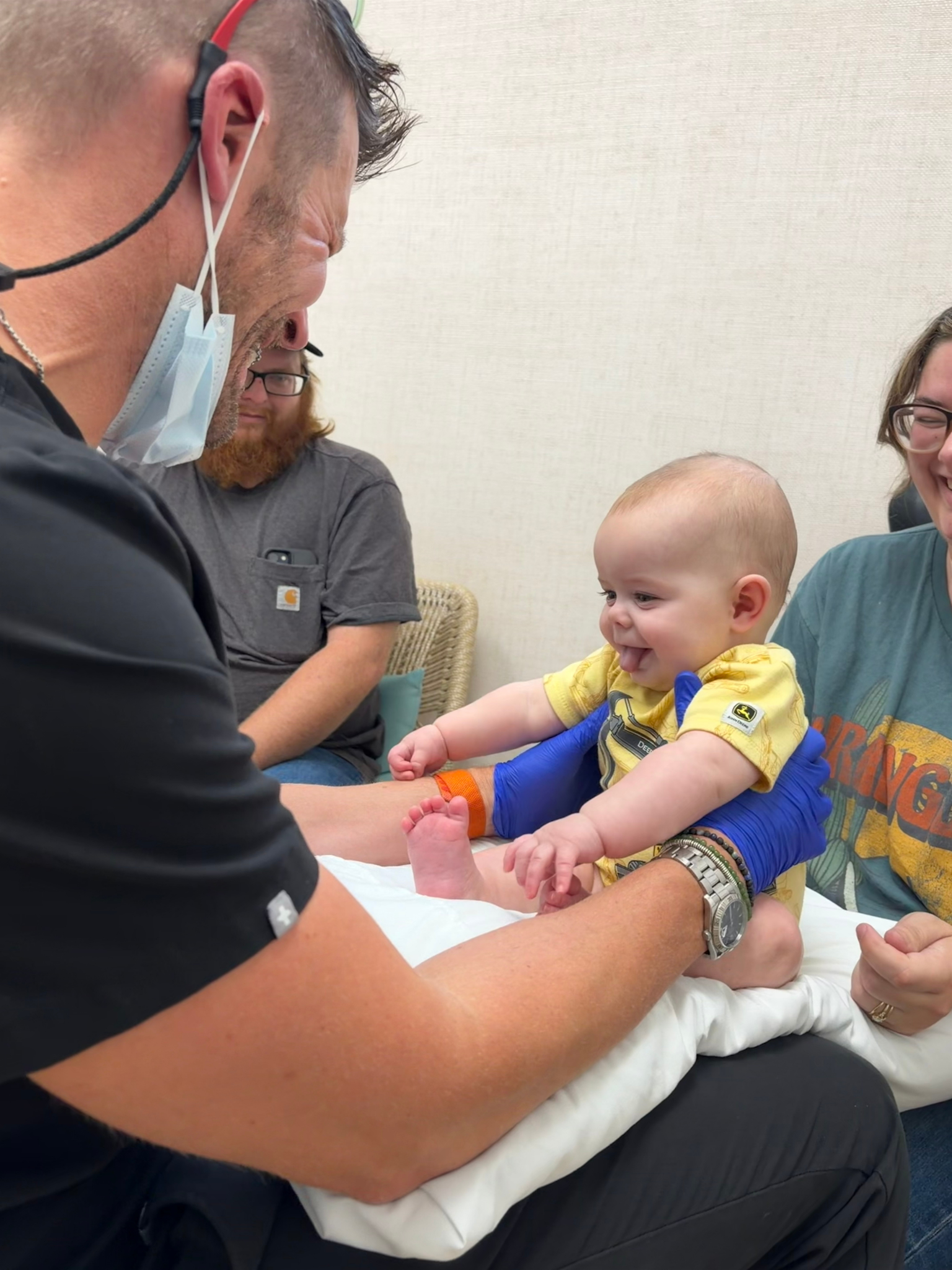 Smiling baby interacting with a Parkview provider during a visit.