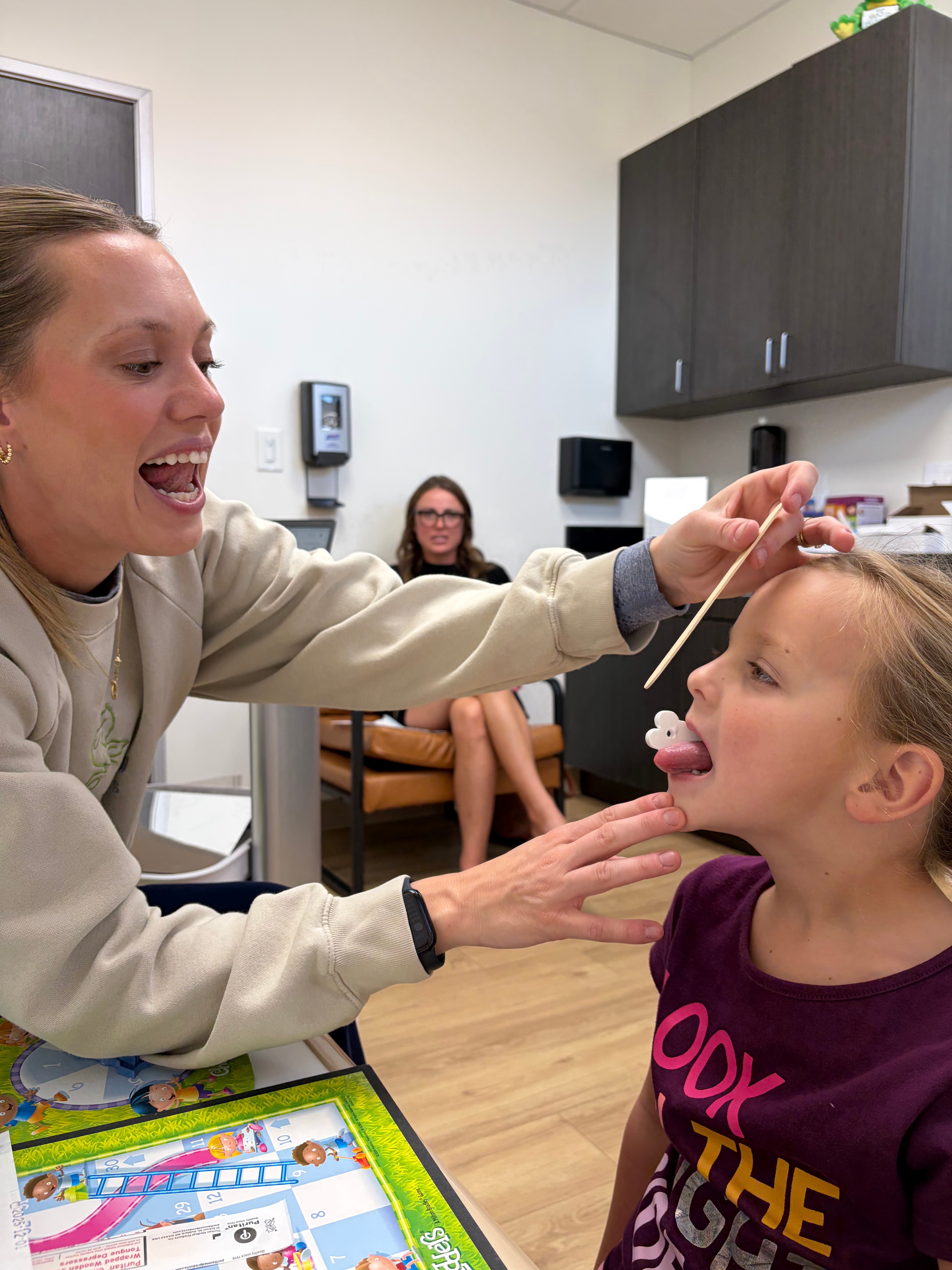 Parkview provider guiding a child through an oral-motor exercise.