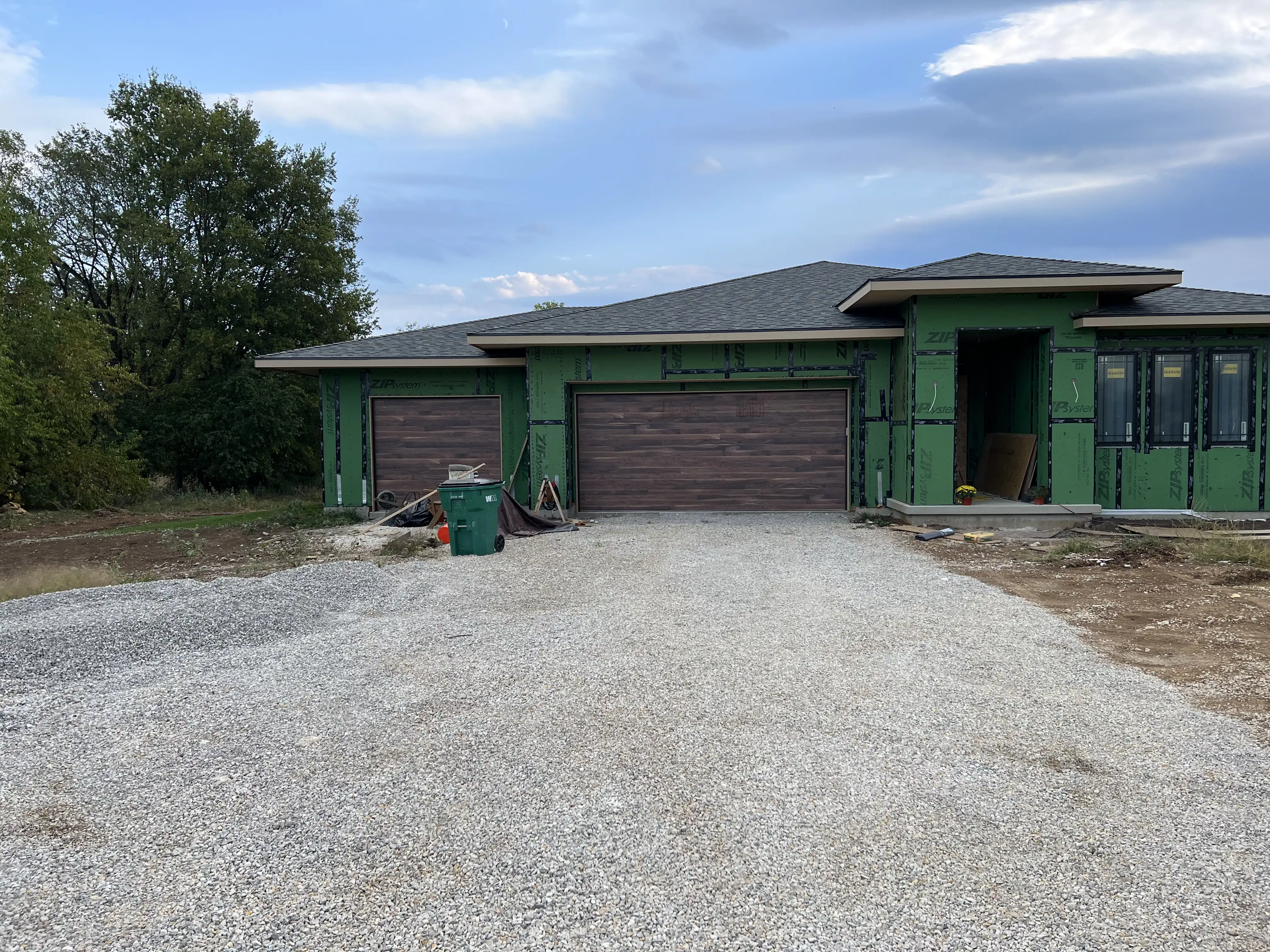 Wind-loaded DoorLink 3700 Ozark garage doors installed on a new construction home in Paola, KS