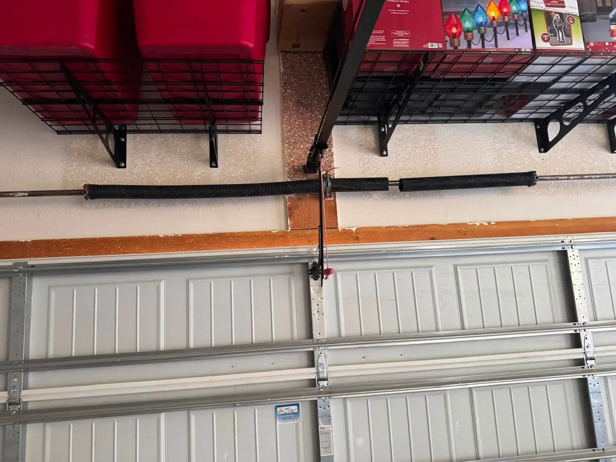 Broken garage door torsion spring in Olathe, KS before replacement