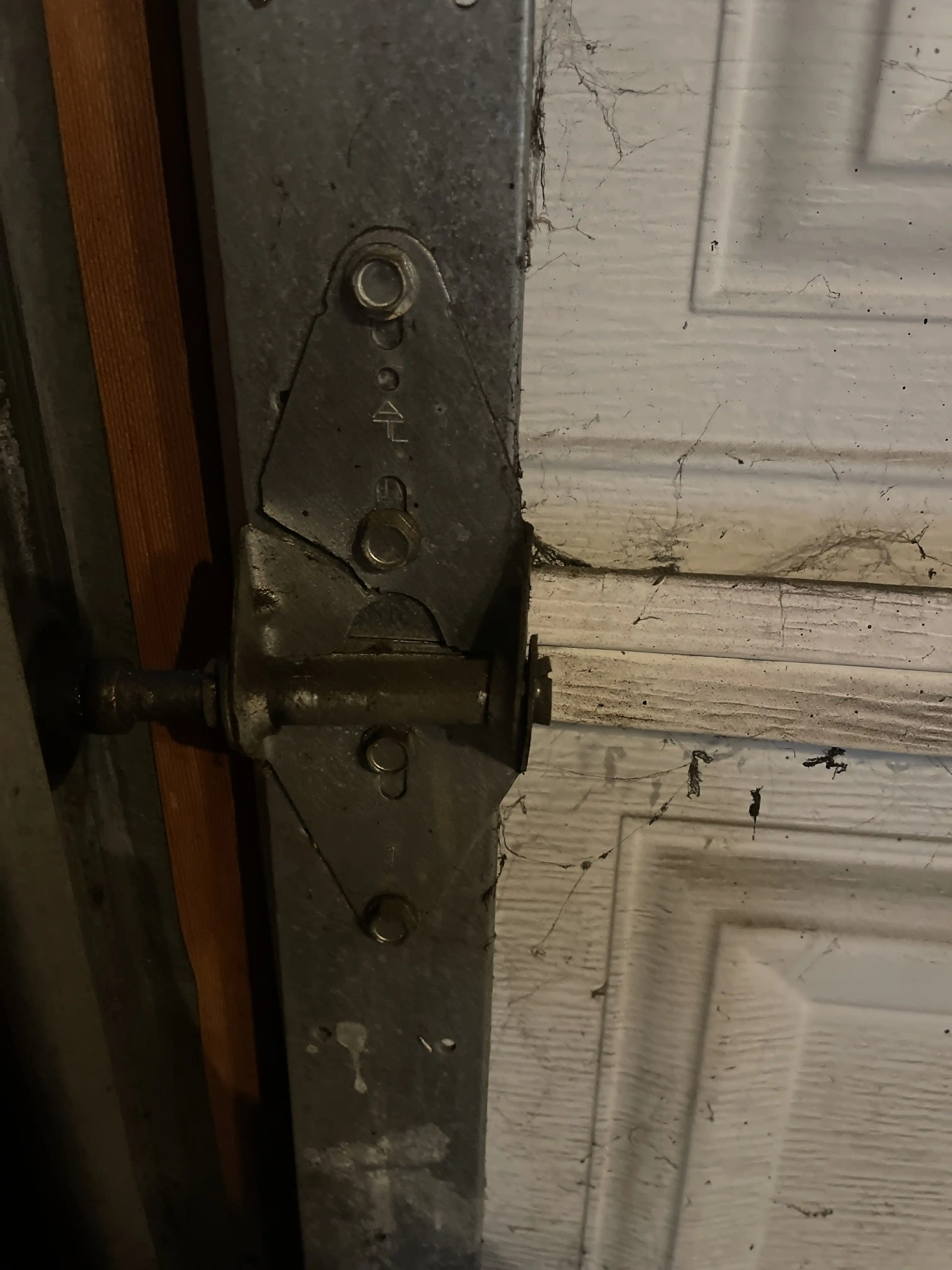 Broken garage door hinge during a repair in Overland Park, KS