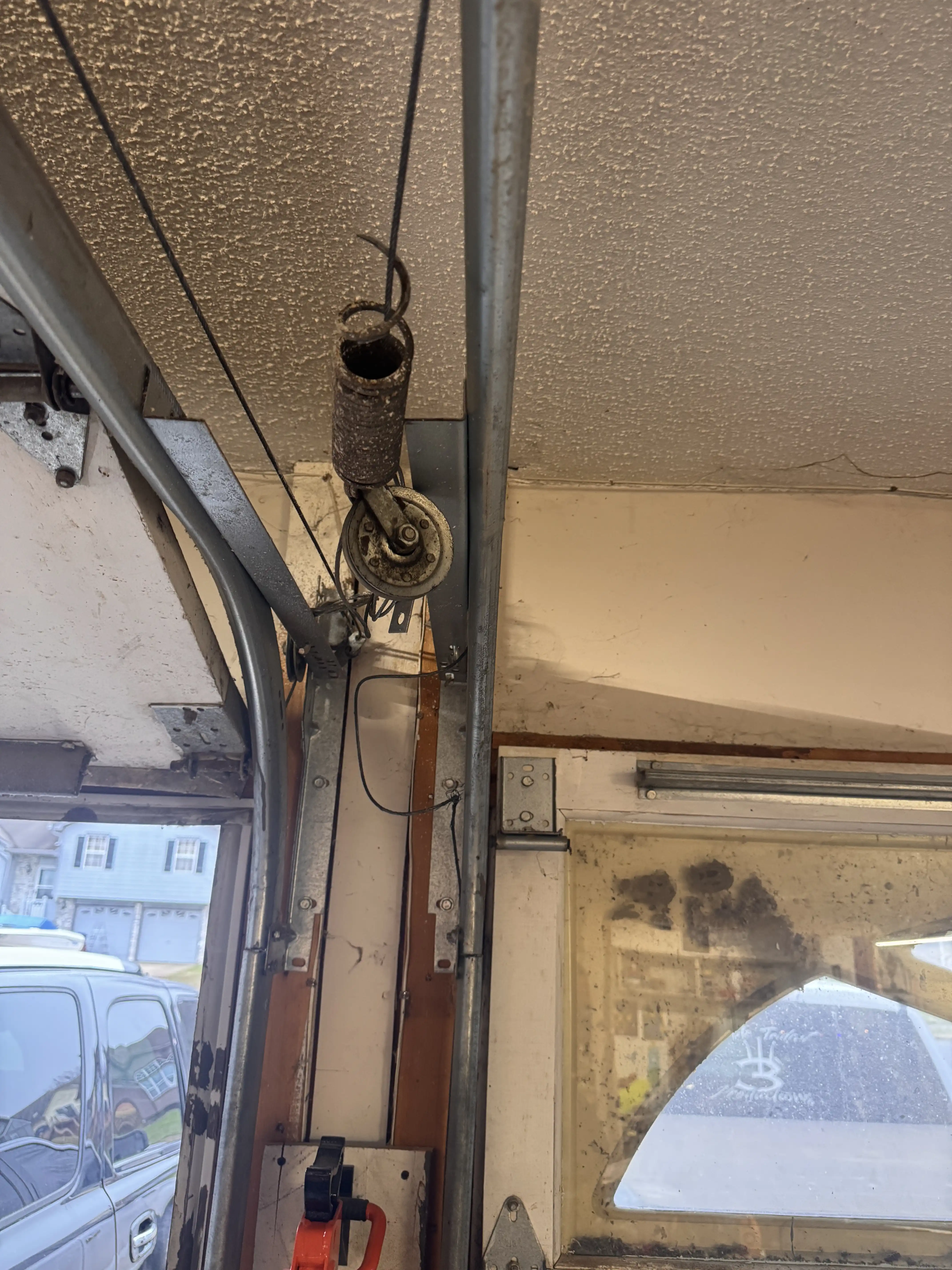 Stretched-out extension spring on a garage door in Belton, MO before replacement