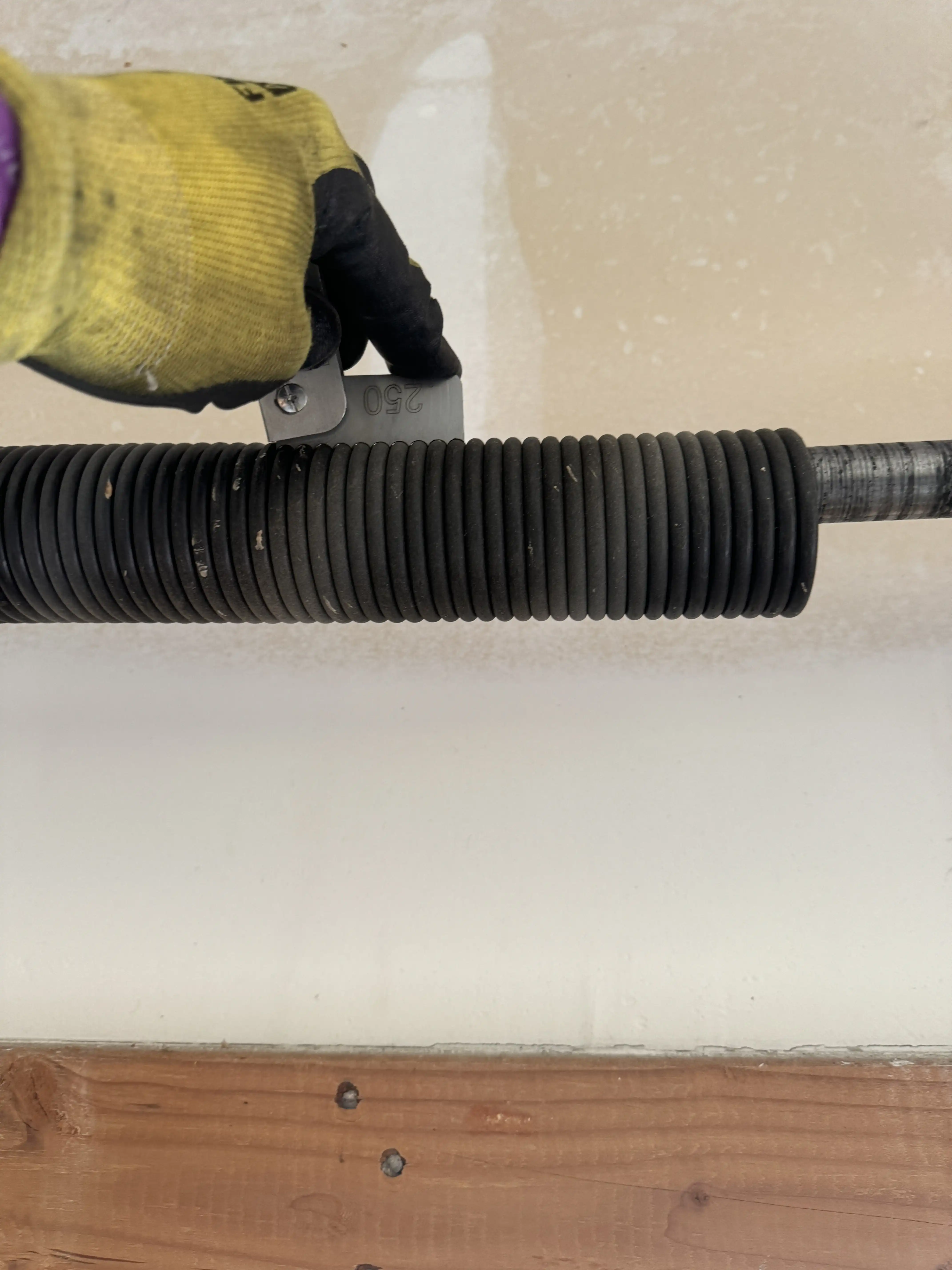 Older garage door with extension springs in Paola, KS before torsion conversion