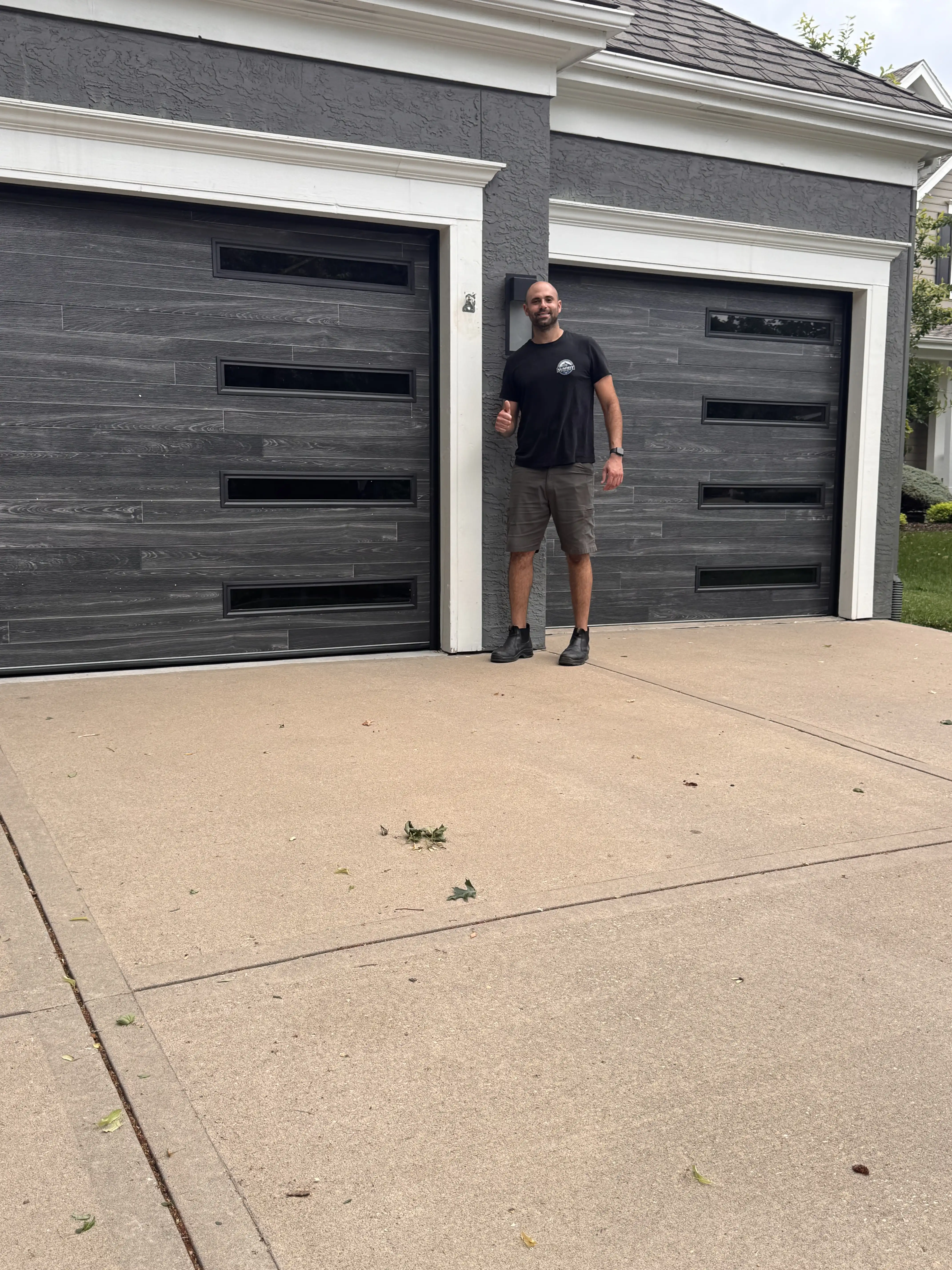 Ben, owner of Summit Garage Door, winding a torsion spring at a job in Overland Park.