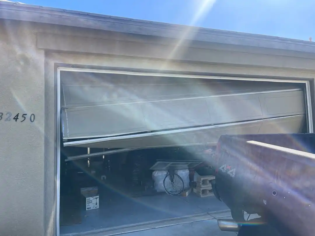 Damaged garage door in Olathe, KS before off-track service