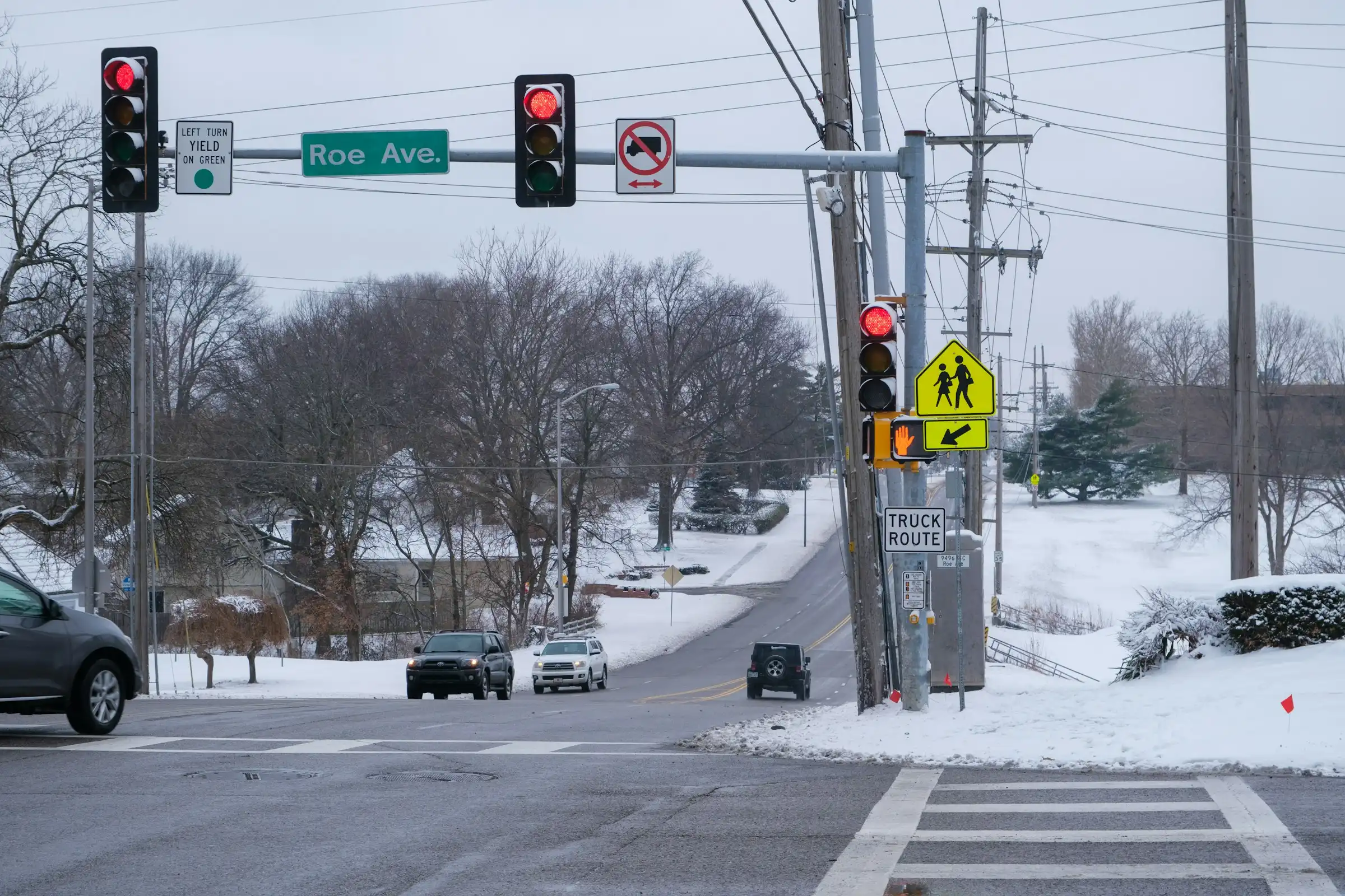 Snowy intersection at Roe Avenue in Prairie Village, Kansas on a grey winter day