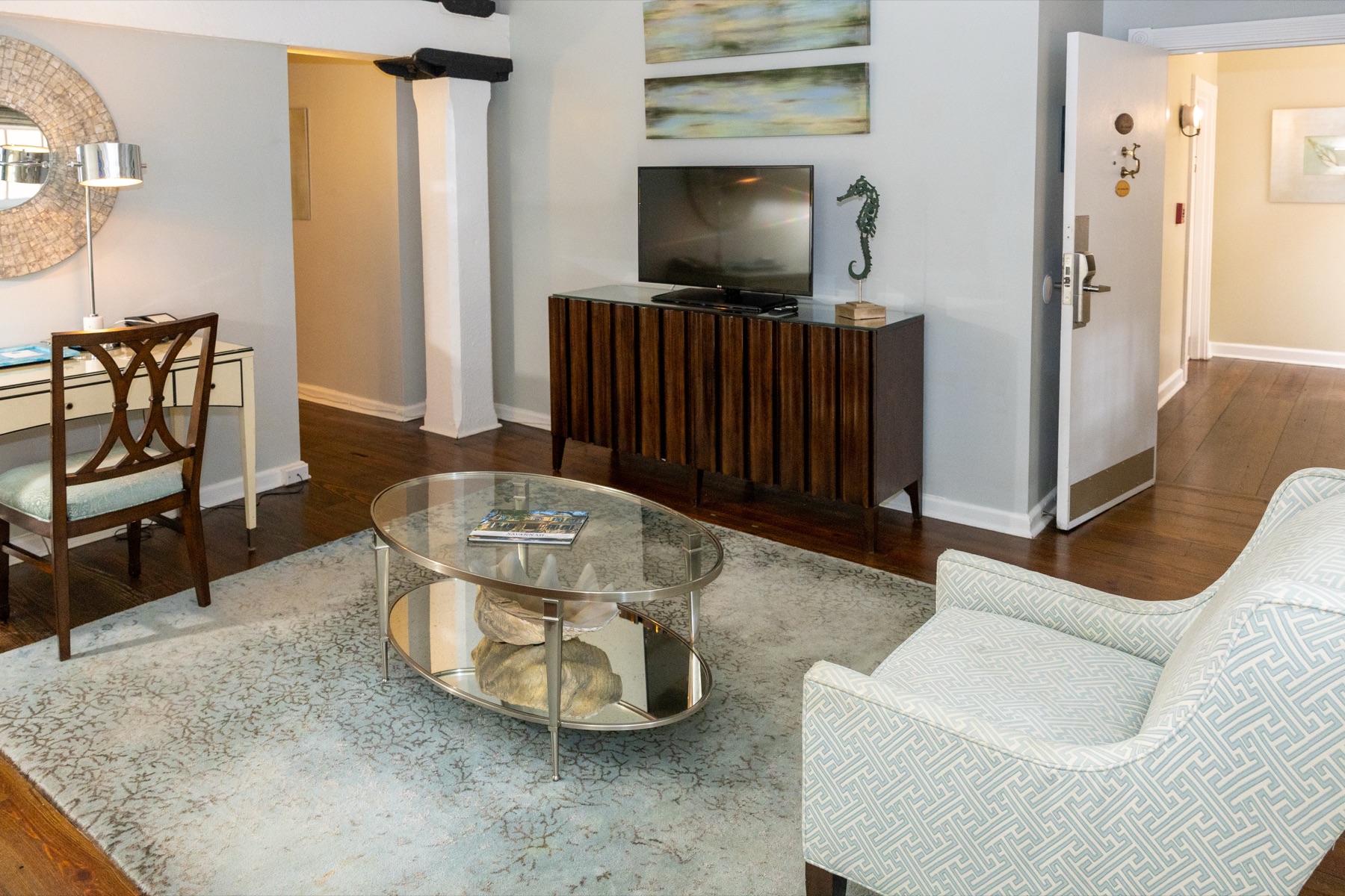 Living area of a suite at Olde Harbour Inn with sitting chairs and wet bar