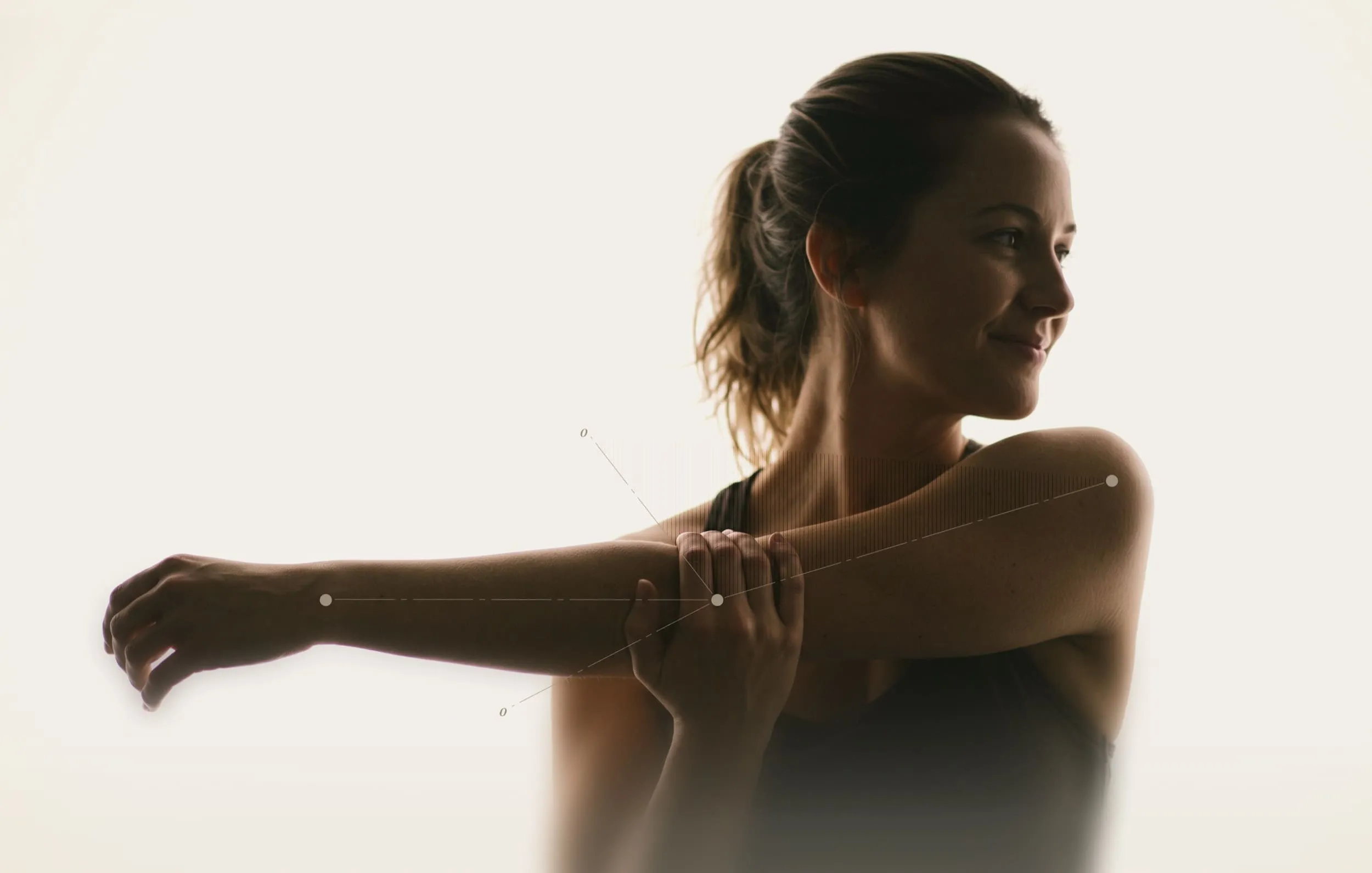 Woman stretching elbow across body highlighting joint anatomy