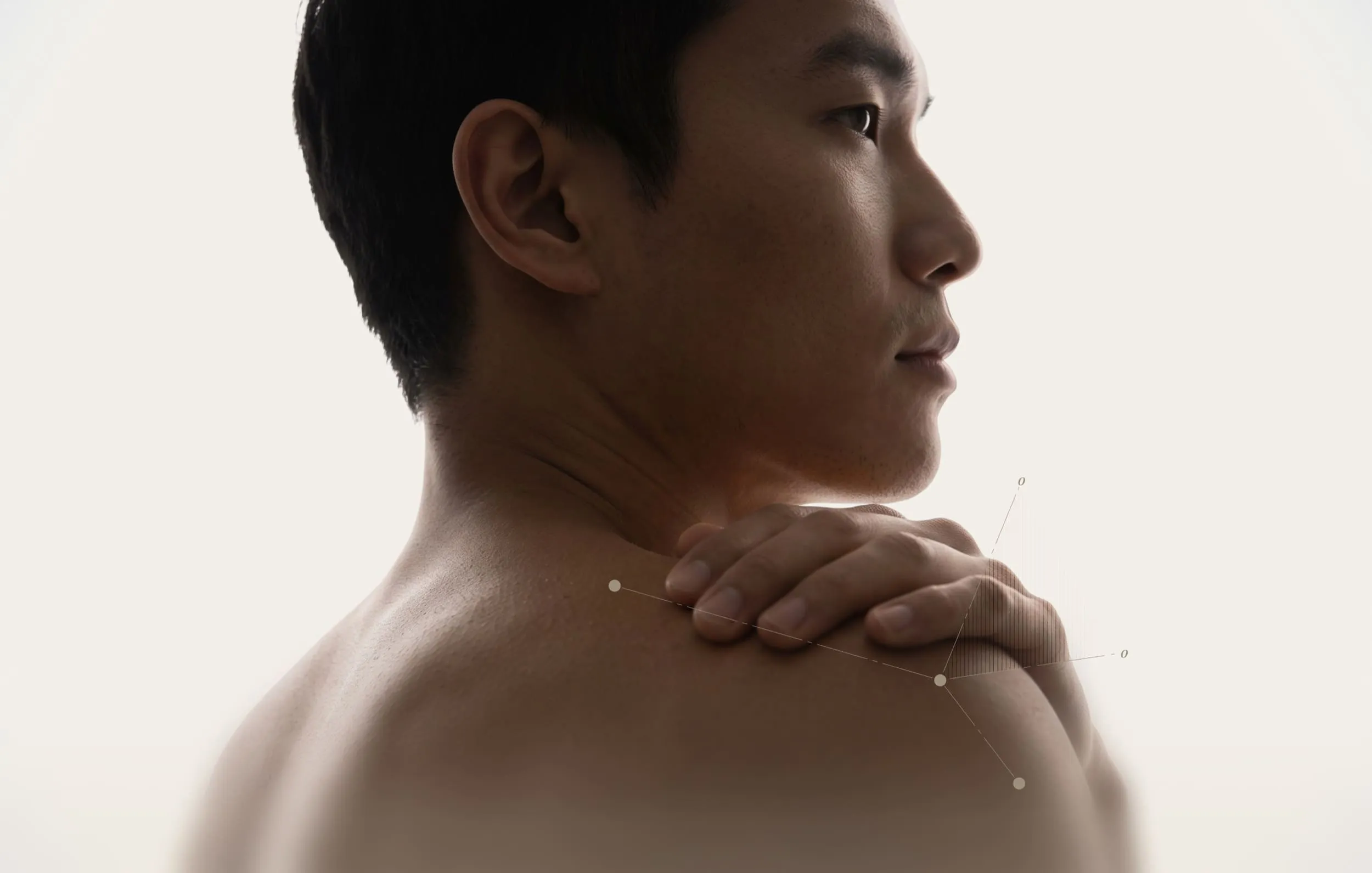 Close-up of male shoulder from behind with hand touching joint