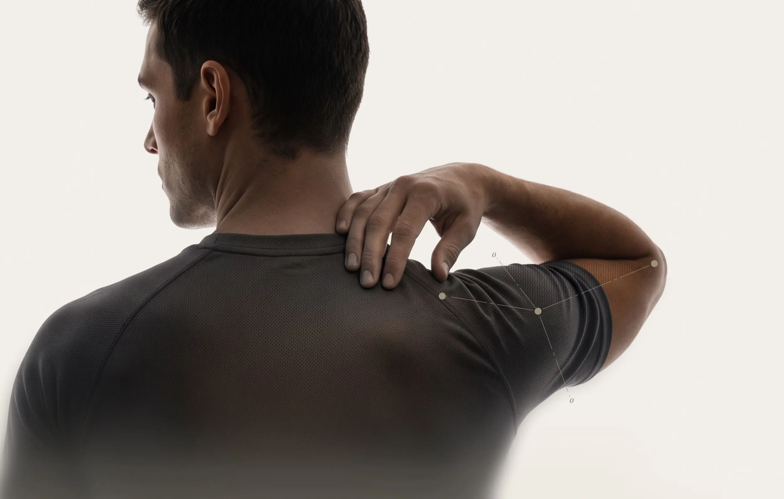 Man in t-shirt from behind touching shoulder for assessment