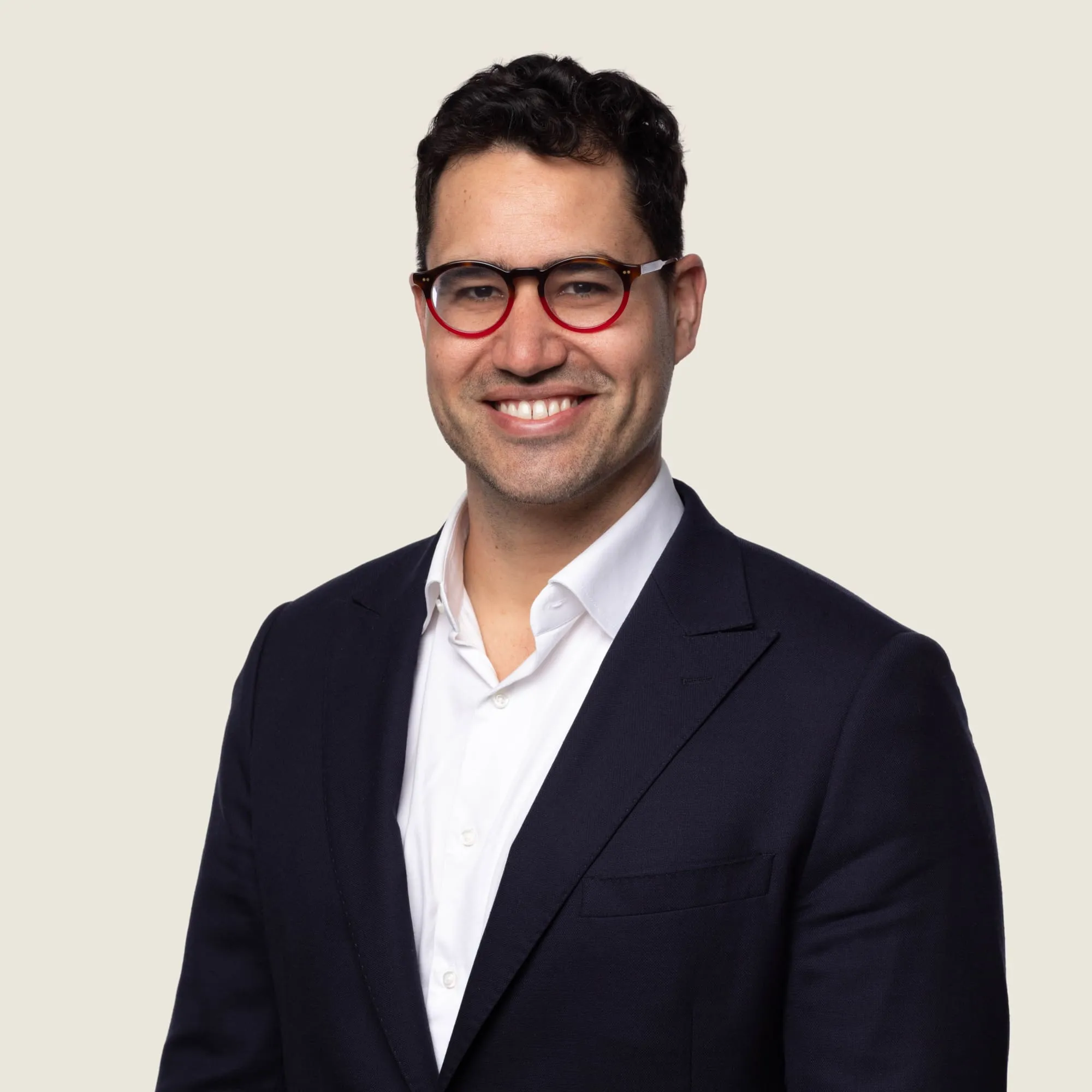 Orthopaedic surgeon Dr Cameron Handford smiling in navy suit