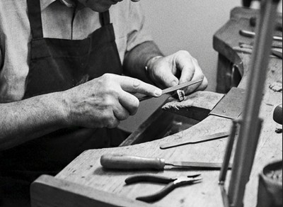 Craftsman hand-finishing a ring in the Enton Jewel workshop