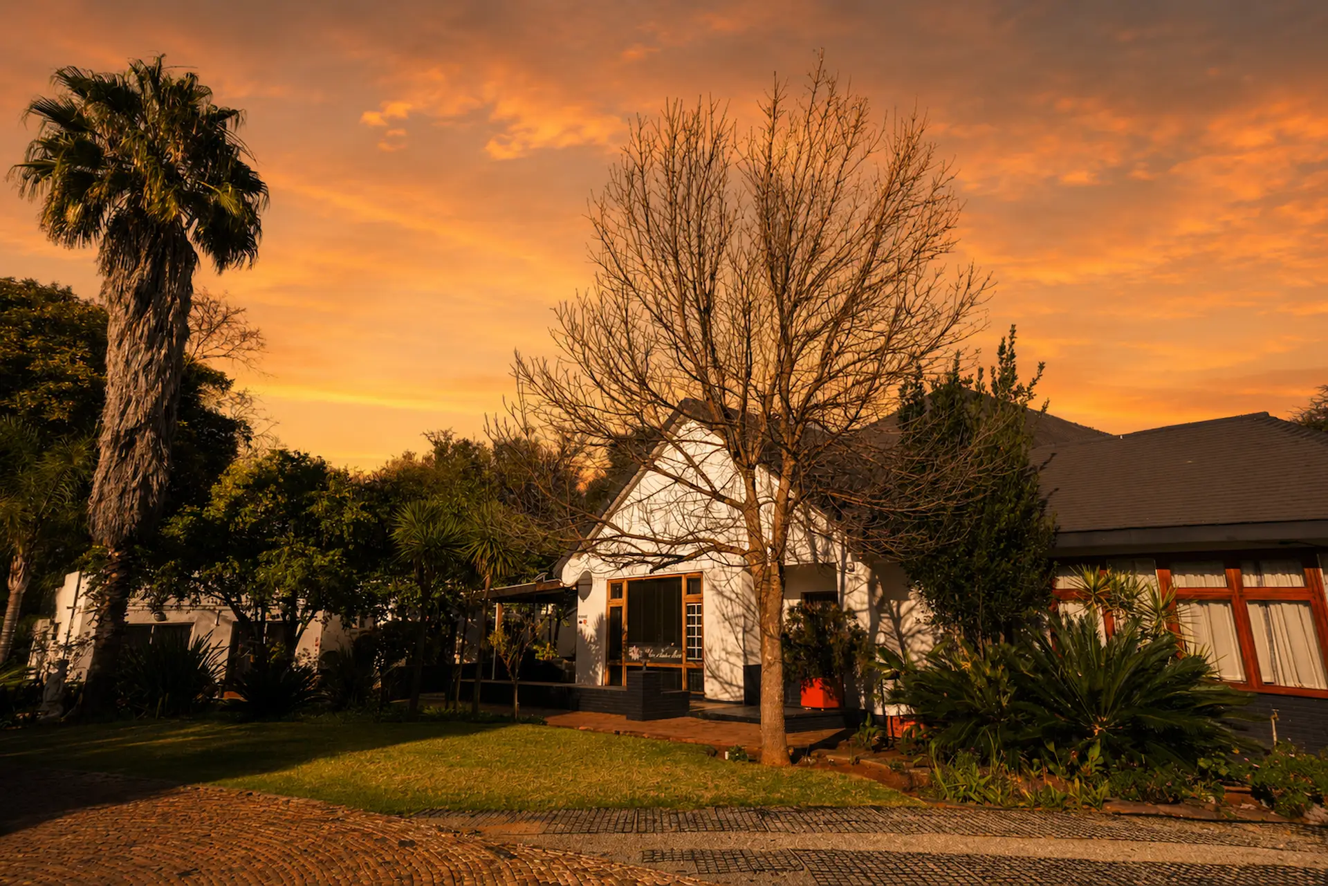 Side view of the main building during a cloudy sunset of St. Joseph's Bed and Breakfast in Irenepark, Klerksdorp.