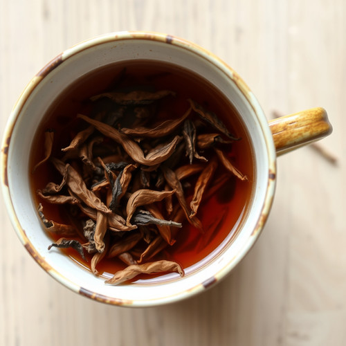 Overhead view of a mug of amber oolong brew with unfurled steeped leaves floating on the surface