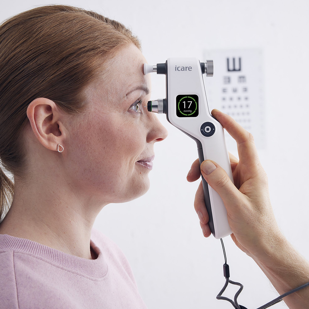Close-up of woman having eye pressure measured with an iCare tonometer held by a hand.