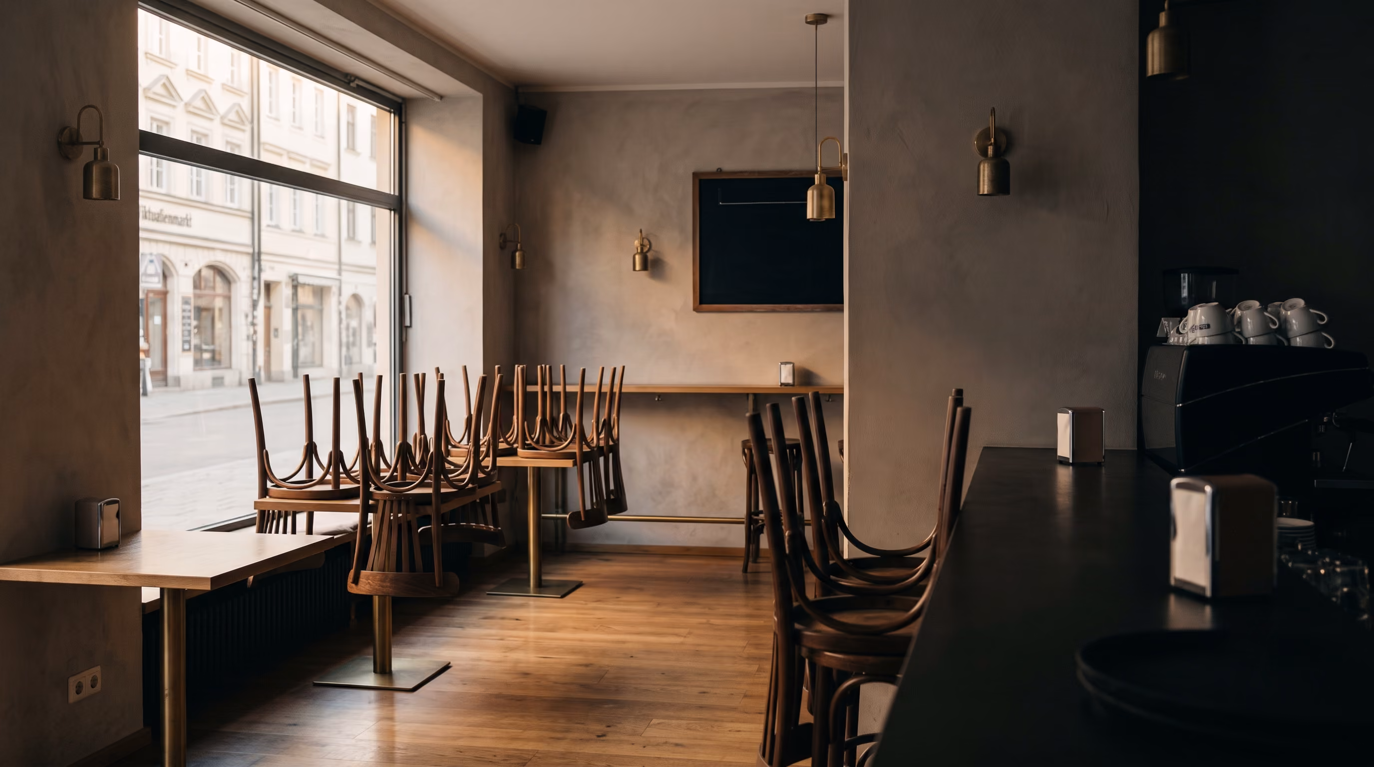 Closed restaurant dining room with chairs stacked on the tables