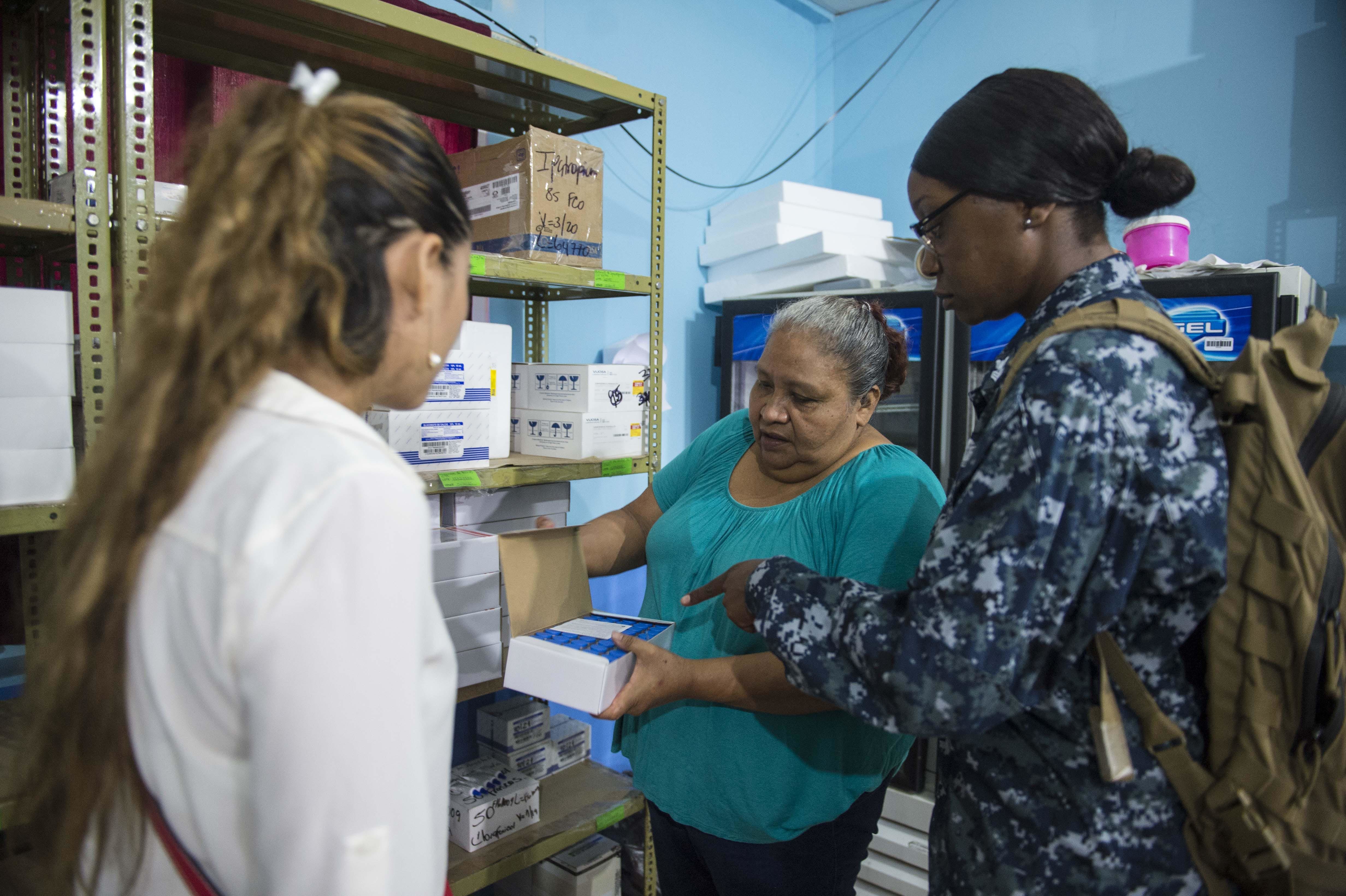 Pharmacy technician preparing and organizing medication in a training pharmacy
