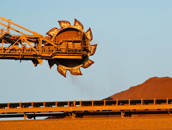 Industrial commodities work image Mining equipment and bulk commodity stockpile representing industrial commodity corridors