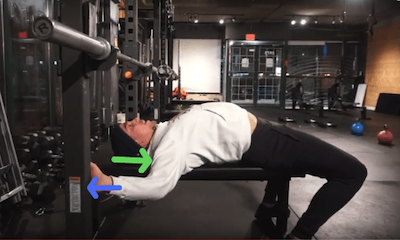 Bench pressing with a flat back causes the shoulder to roll forward