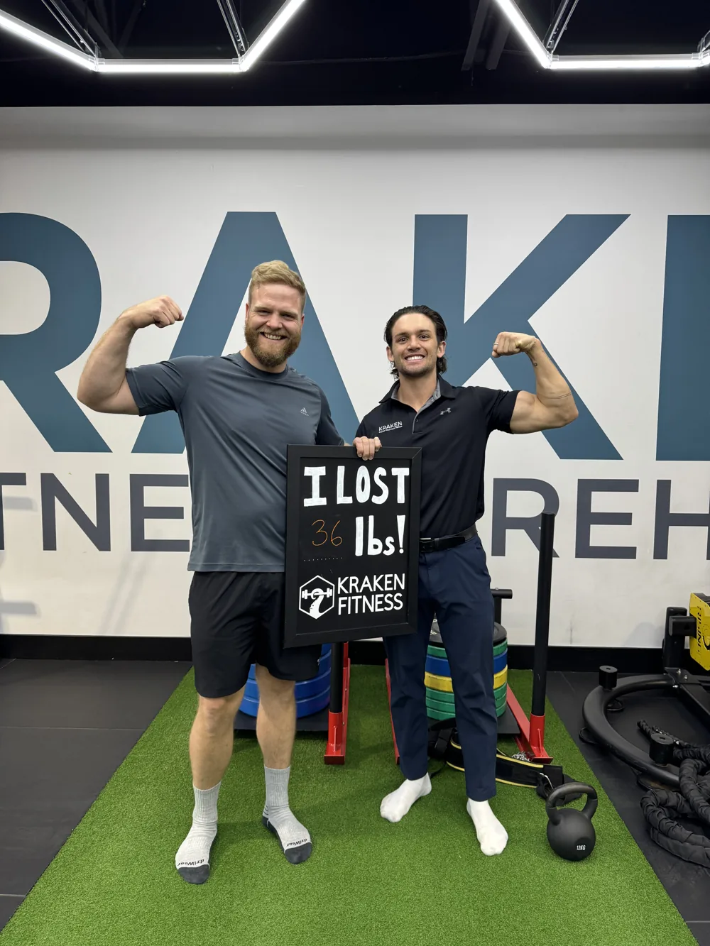 Matt holding an I lost 36 lbs chalkboard at Kraken Fitness