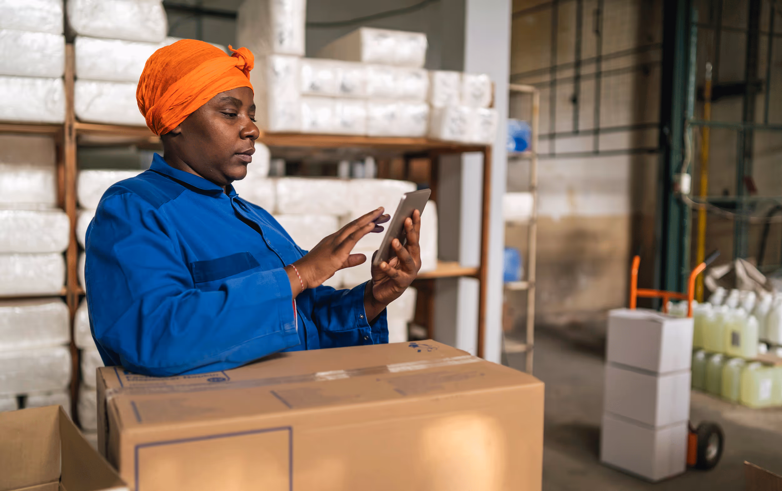 A black woman checks data o a small tablet
