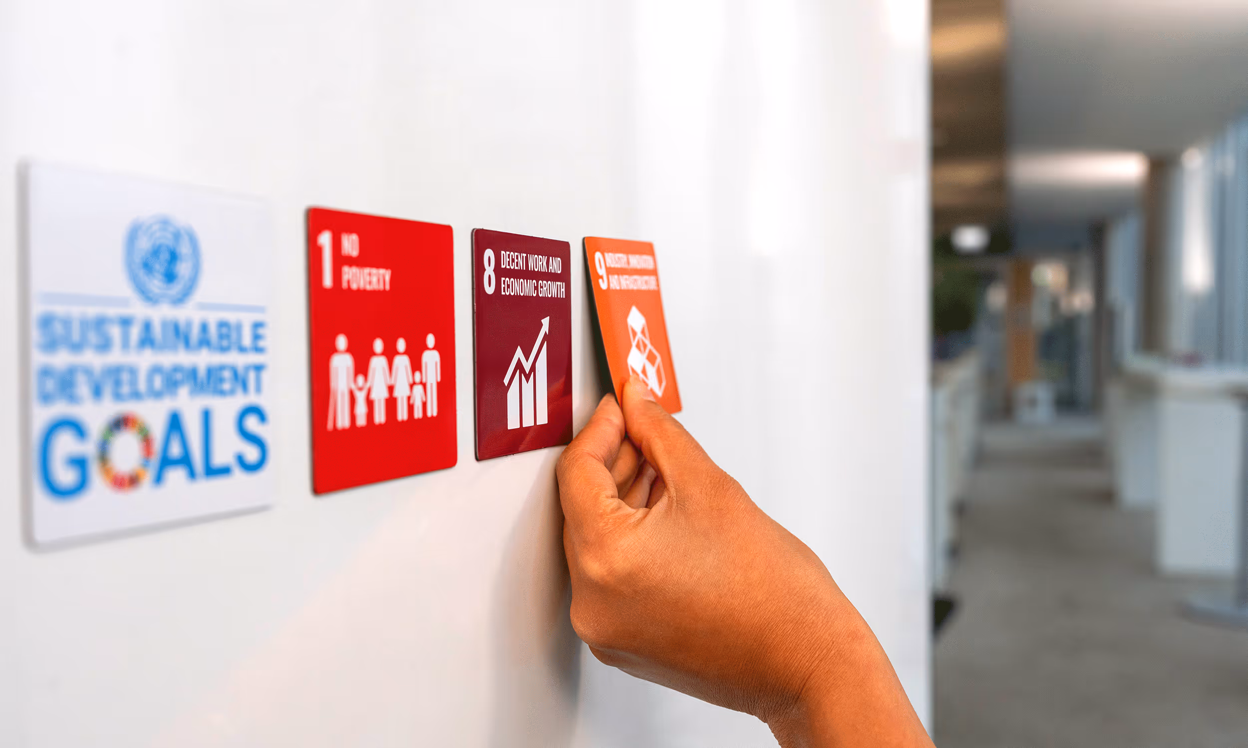 Hand replaces SDG badges on a Door