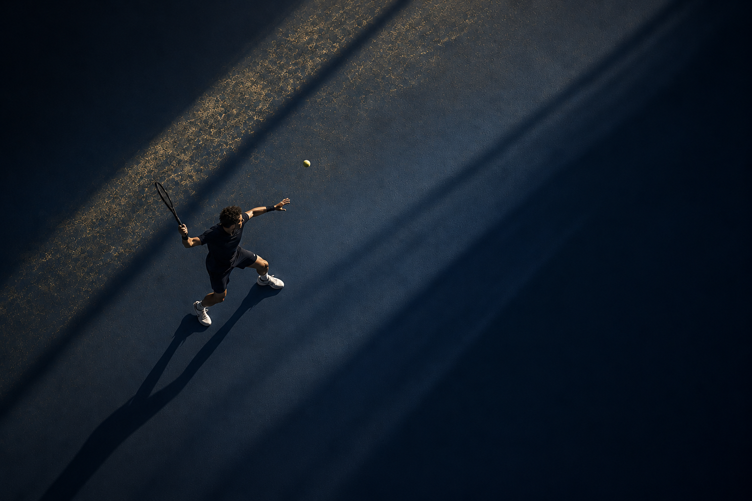 Tennis player serving on a dark court