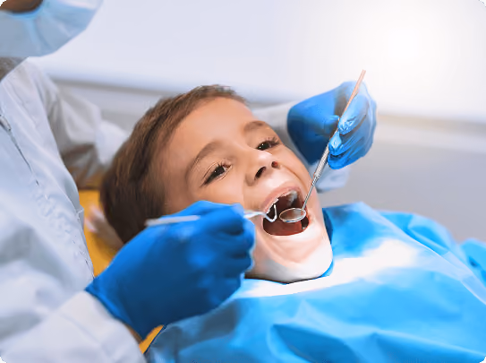 Smiling man sitting in a dental chair giving a thumbs-up in a bright dental office.