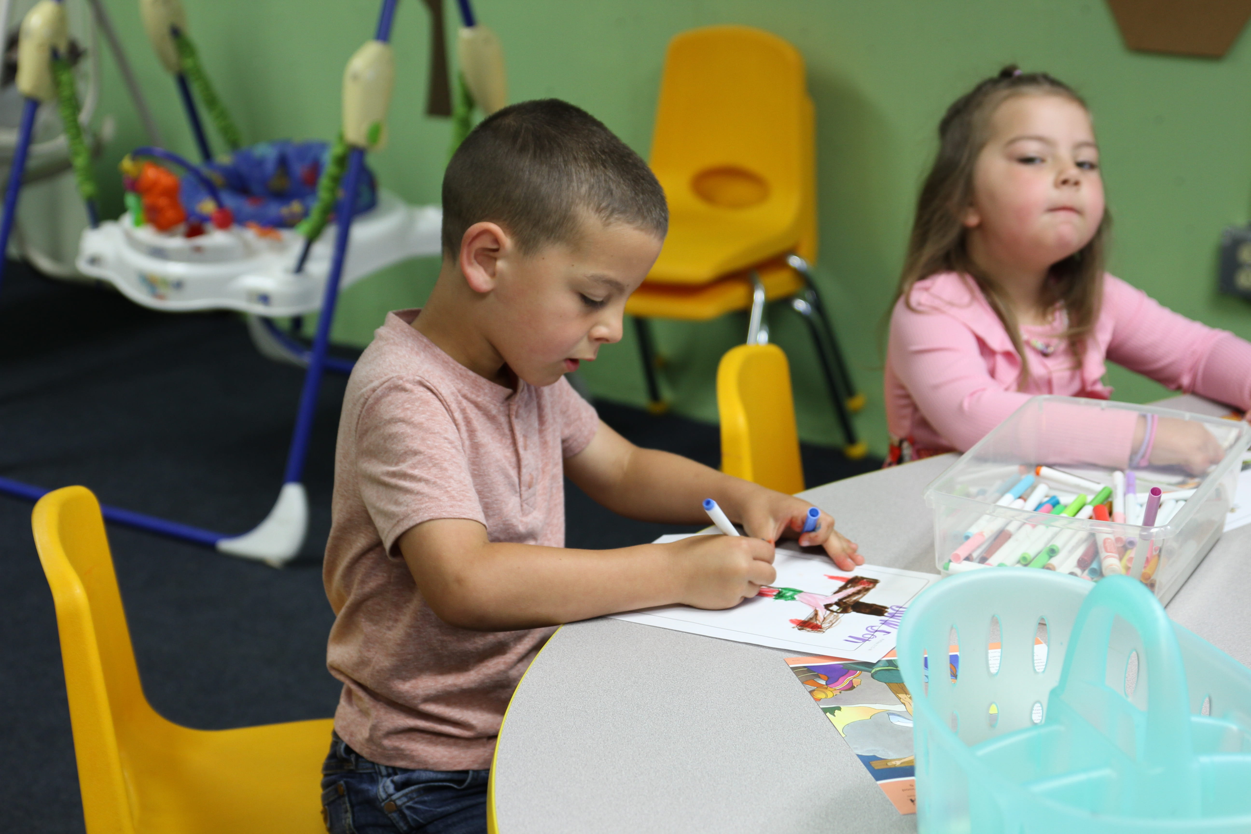 Two children color in Sunday School at Trinity Lutheran Church in Paola, Kansas 