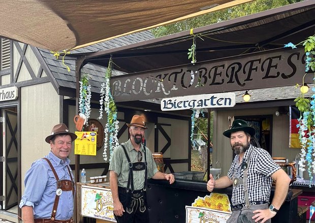 Three men meet up at a biergarten dressed in German hats and lederhosen. The biergarten is located at Blocktober Fest at Trinity Paola Lutheran Church. 