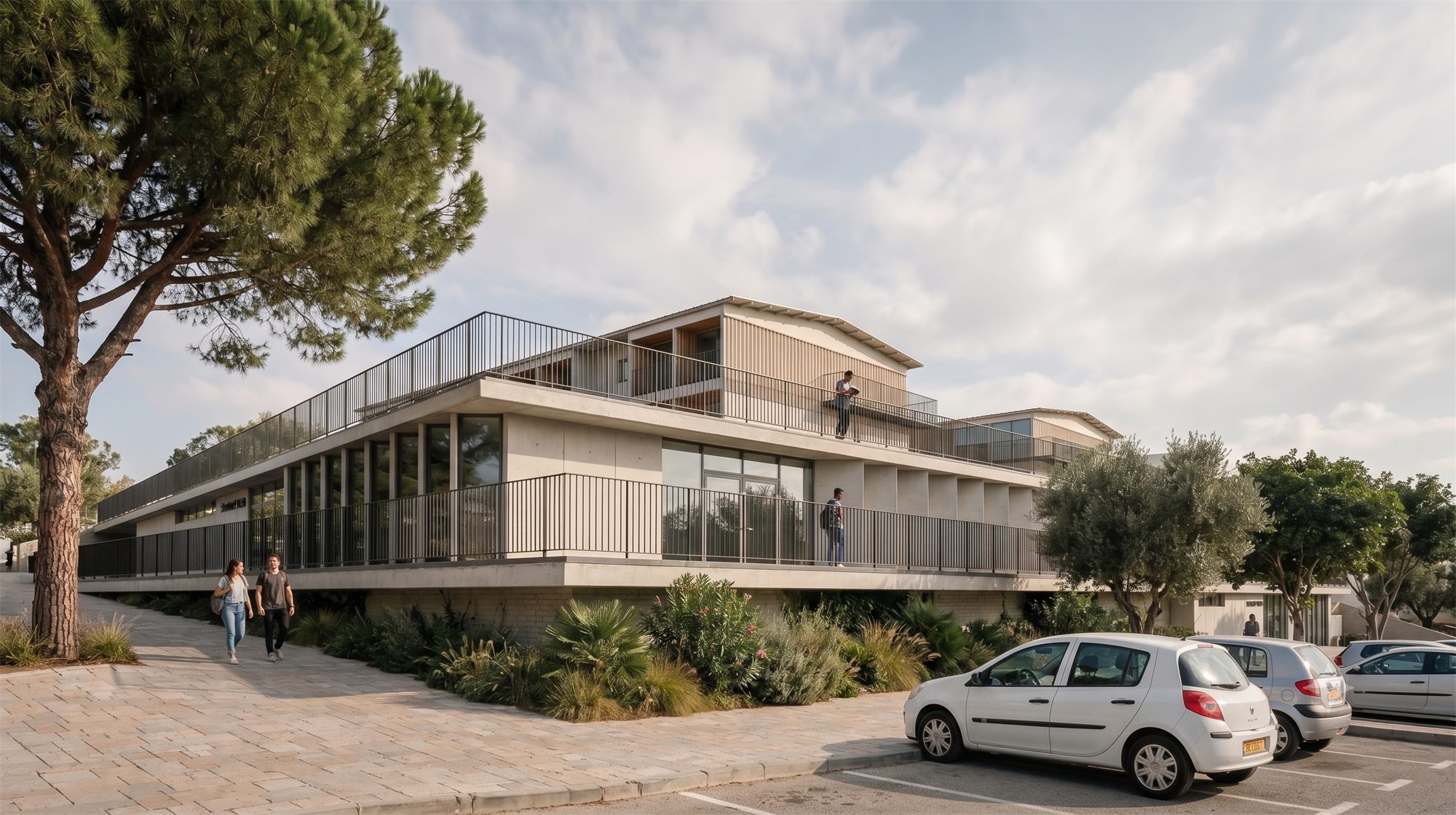 Modern two-story building with large windows, surrounded by trees, cars, and students outside.