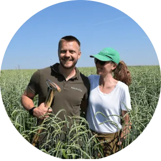 a man and a woman standing in a field