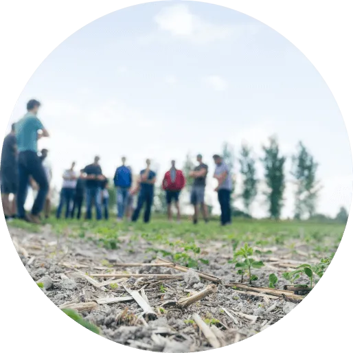 a group of people standing in a field
