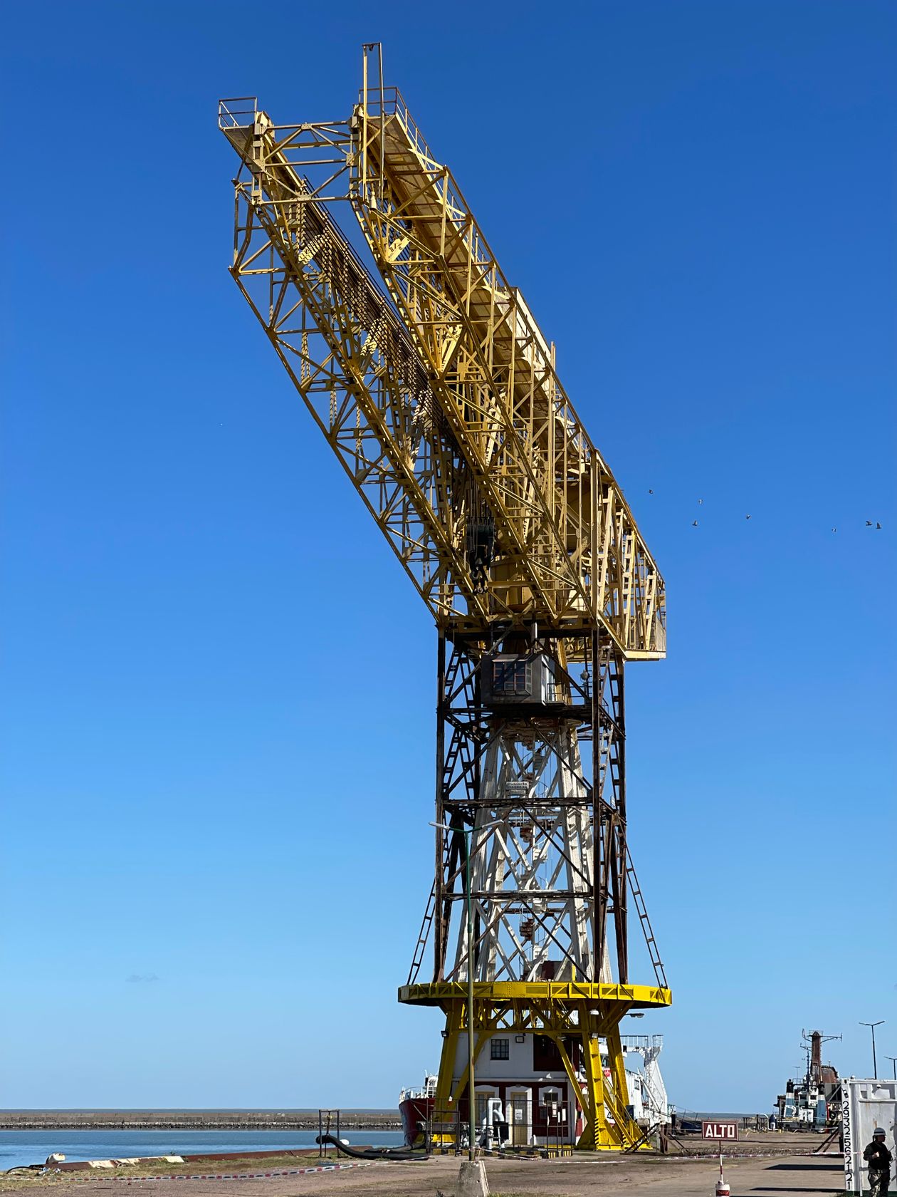 Yellow crane at a cargo port pier