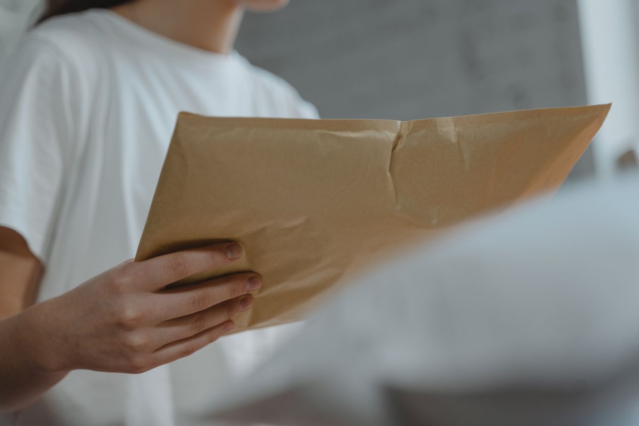 Close-up of a person holding a packaged parcel
