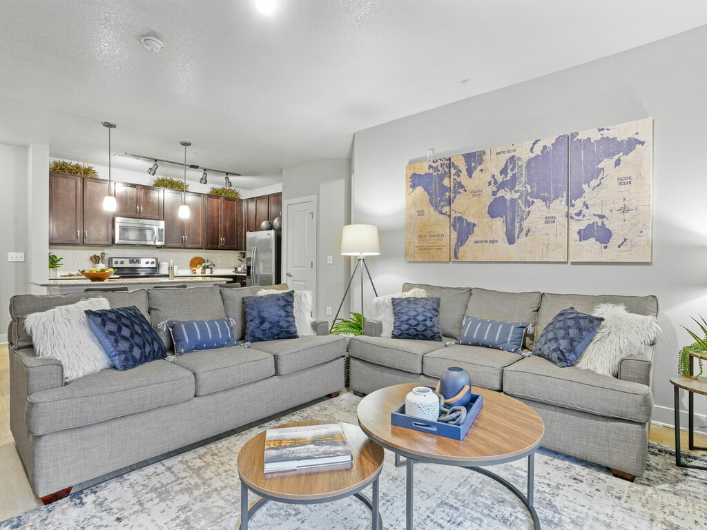Living area with sofa, coffee table, and view of kitchen