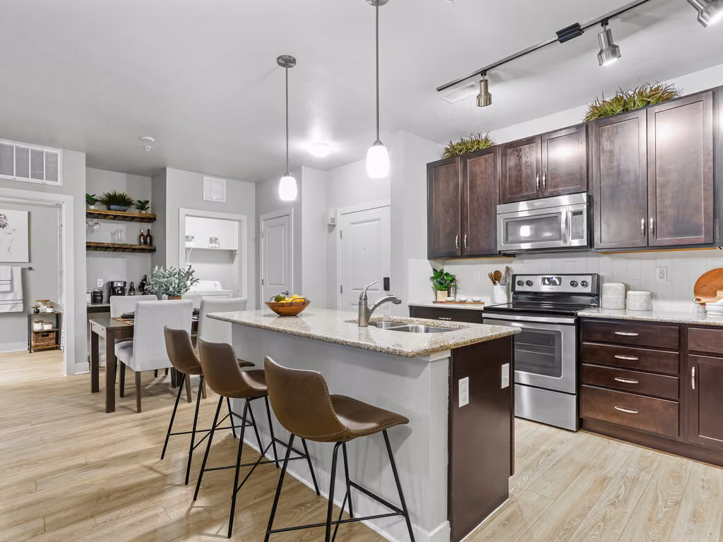 Kitchen with island and brown cabinets with stainless steel appliances