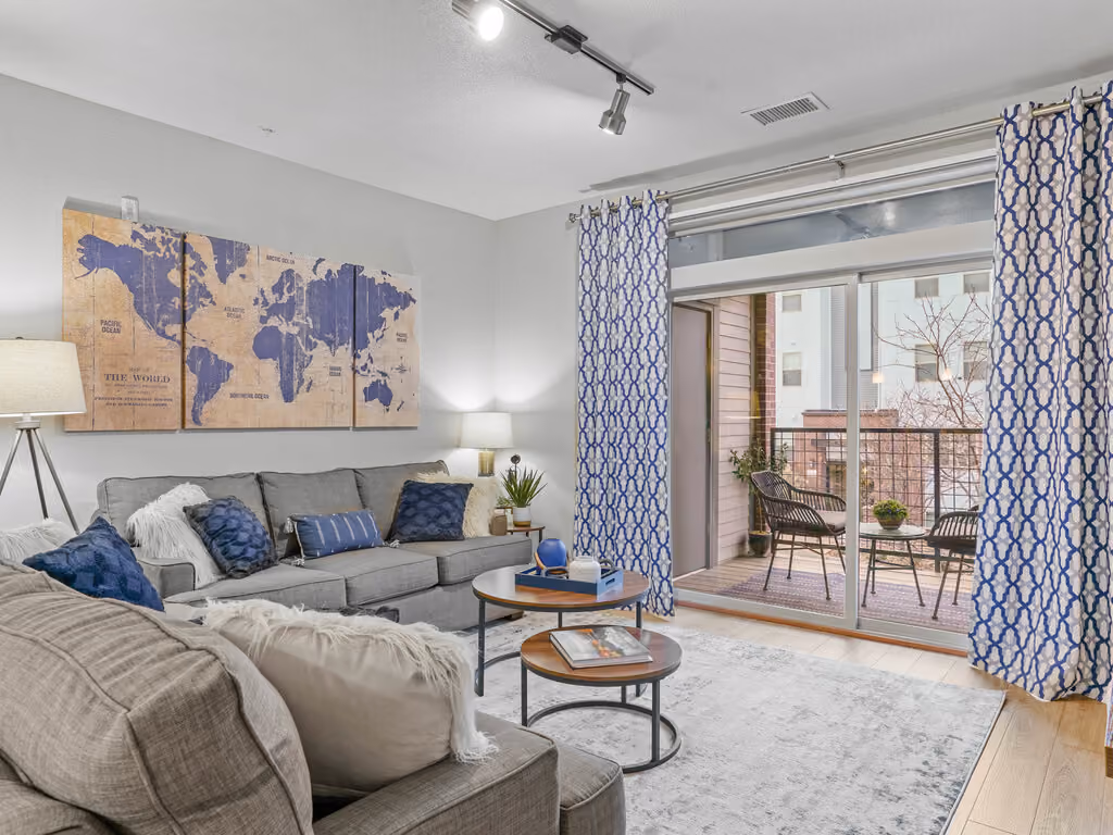 Living area with sofa, coffee table, and view of patio