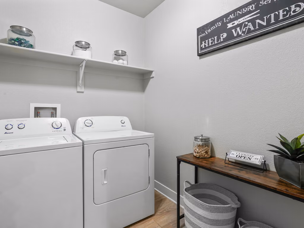 Laundry room with white appliances