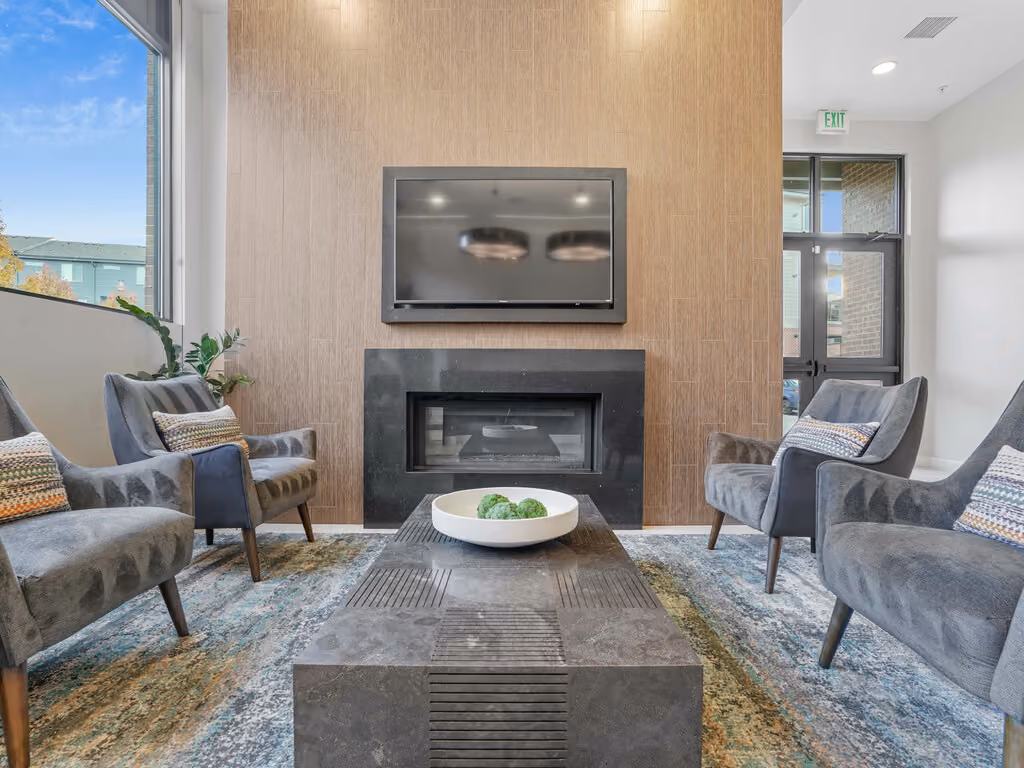 Community lounge area with fireplace and tv