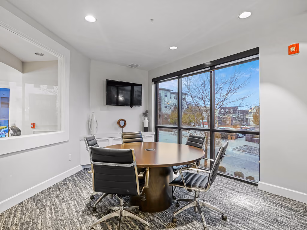 Business center with table with chairs and tv